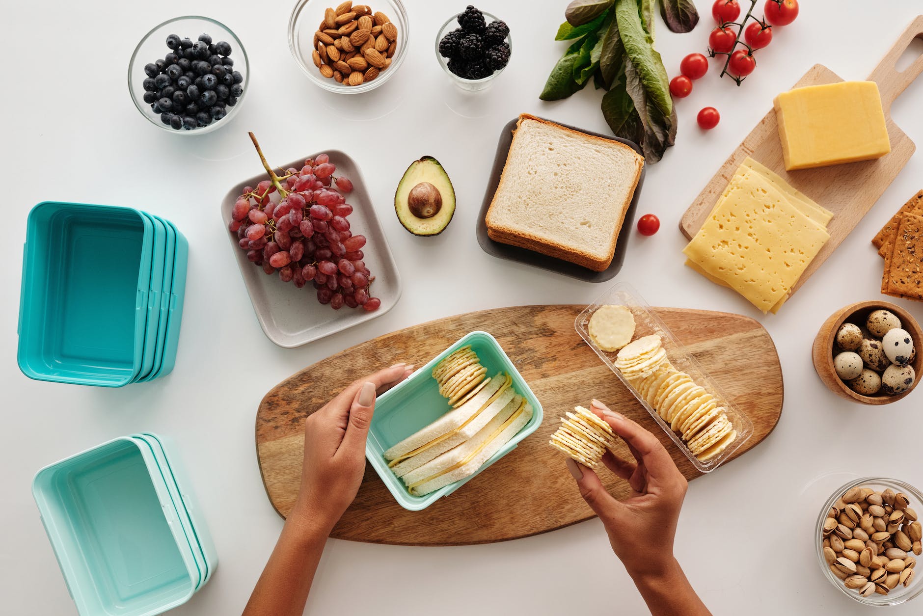 a person holding a plastic container with bread and biscuits